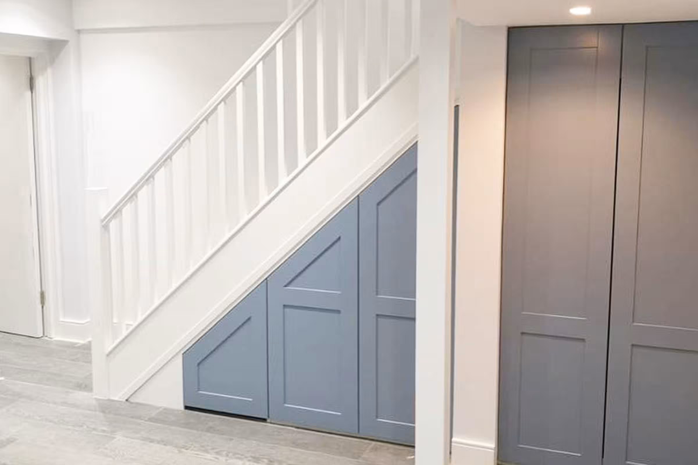 Bespoke custom alcove cabinets with open shelving and concealed storage built into a Richmond TW10 living room
